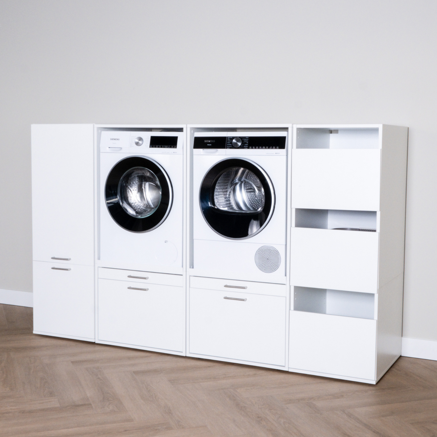 White laundry storage unit with integrated front-loading washer, dryer, cabinets, and open shelves.