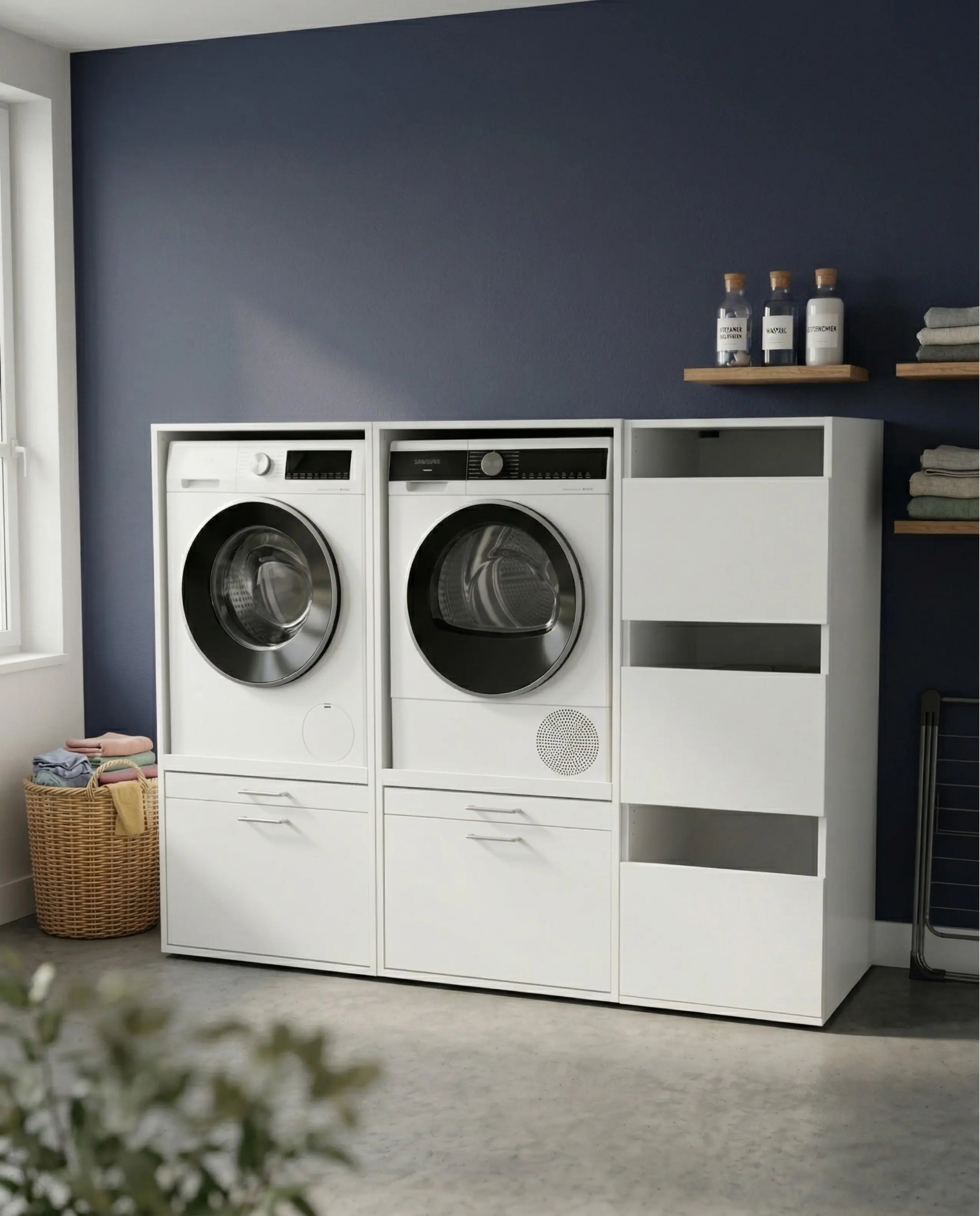 White Duo Set Low 3 laundry storage unit with front-loading washer, dryer, and side compartments against a dark blue wall.